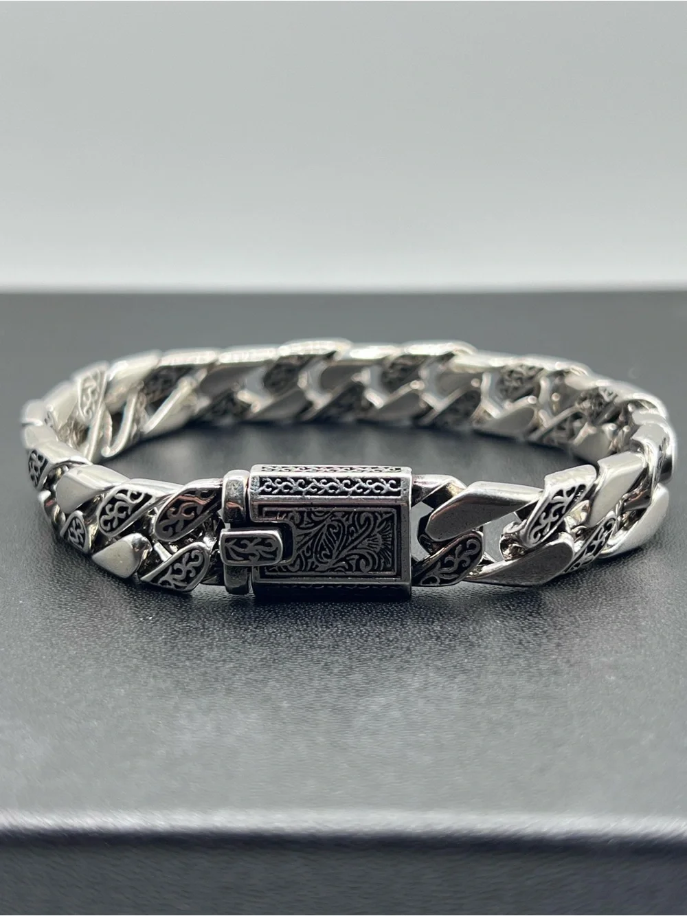 Engraved Cuban Link Bracelet with a secure clasp closure